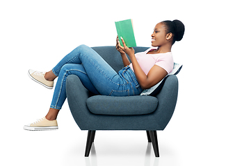 Image showing happy young woman in armchair reading book