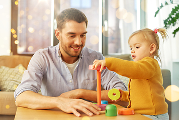 Image showing father playing with little baby daughter at home