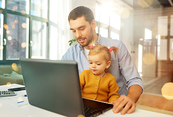 Image showing working father with baby daughter at home office