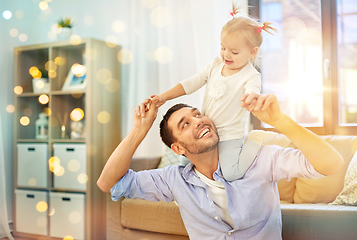 Image showing father riding little baby daughter on neck at home