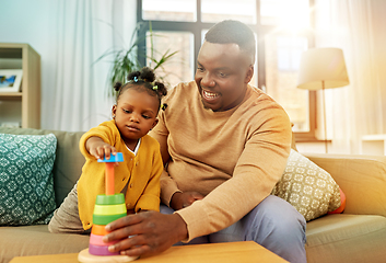 Image showing african family playing with baby daughter at home