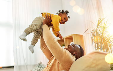 Image showing happy african american father with baby at home