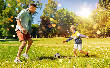 Image showing father with little son playing soccer at park