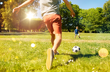 Image showing father with little son playing soccer at park