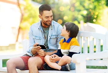 Image showing father and son with smartphone at park