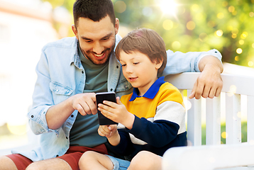 Image showing father and son with smartphone at park