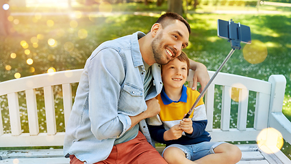 Image showing father and son taking selfie with phone at park