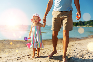 Image showing father walking with little daughter on beach