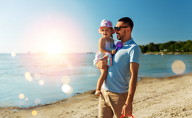 Image showing happy father with little daughter on beach