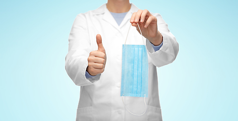 Image showing female doctor with medical mask showing thumbs up