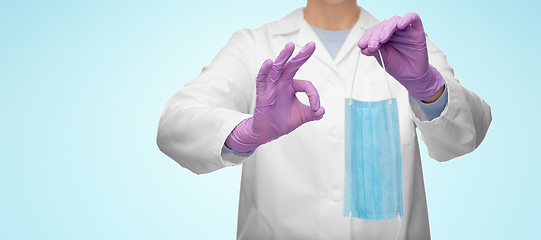 Image showing female doctor with medical mask showing ok gesture