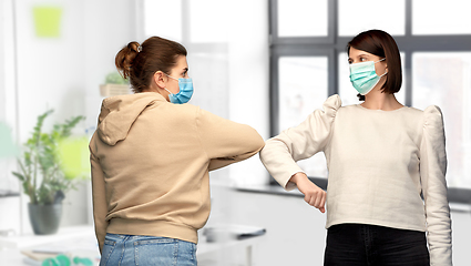 Image showing women in masks making elbow bump greeting gesture