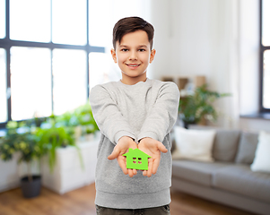 Image showing smiling boy holding green house icon