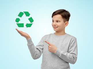 Image showing smiling boy showing green recycling sign