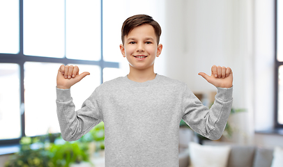 Image showing happy smiling boy pointing fingers at himself