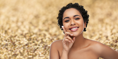 Image showing young african american woman with moisturizer