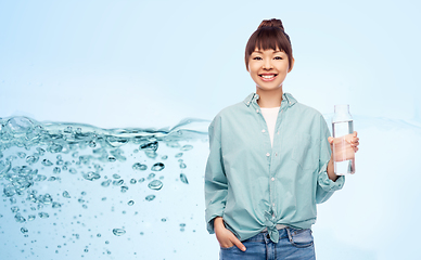 Image showing happy asian woman holding glass bottle with water