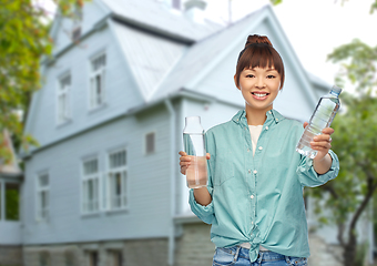 Image showing asian woman with plastic and glass bottle of water