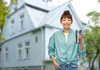 Image showing woman with thermo cup or tumbler for hot drinks