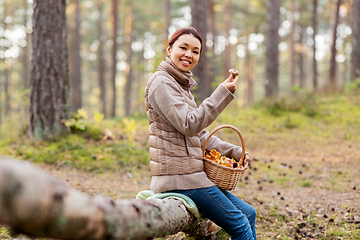 Image showing woman with mushrooms in basket in autumn forest