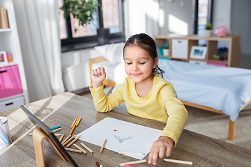 Image showing little girl drawing with coloring pencils at home