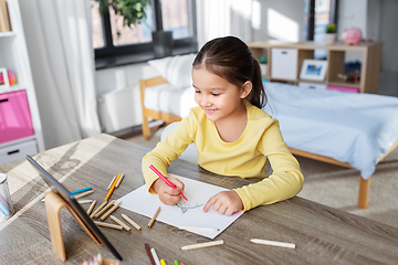 Image showing little girl drawing with coloring pencils at home