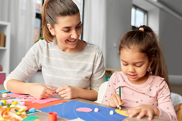 Image showing daughter with mother making applique at home