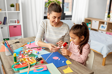 Image showing daughter with mother making applique at home