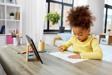 Image showing little girl drawing with coloring pencils at home