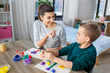 Image showing mother and son playing with modeling clay at home