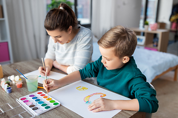 Image showing mother and son with colors drawing at home