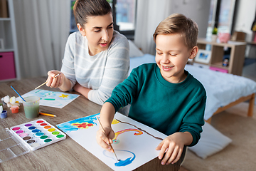 Image showing mother and son with colors drawing at home