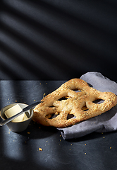 Image showing close up of cheese bread, butter and table knife