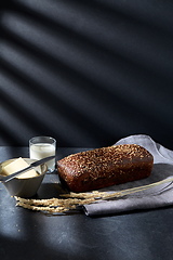 Image showing close up of bread, butter, knife and glass of milk