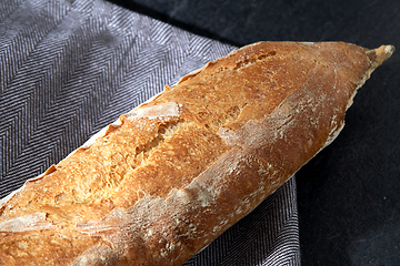 Image showing close up of baguette bread on kitchen towel