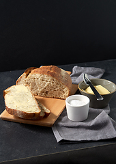 Image showing close up of bread, butter, knife and salt on towel