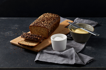 Image showing close up of bread, butter, knife and salt on towel