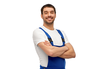 Image showing happy smiling male worker or builder in overall