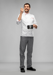 Image showing happy smiling male chef with saucepan tasting food