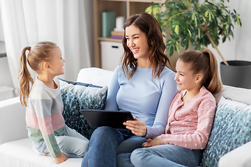 Image showing happy mother and daughters with tablet pc at home