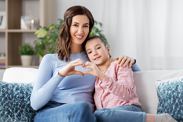 Image showing happy smiling mother with daughter at home