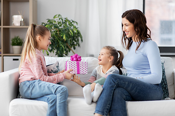 Image showing girl giving present to younger sister at home