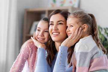 Image showing happy smiling mother with two daughters at home
