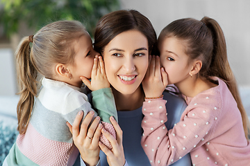 Image showing happy mother and daughters gossiping at home