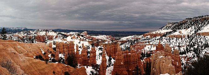 Image showing Bryce canyon panorama in overcast winter day with orange rocks and snow