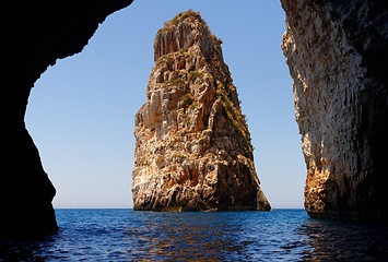 Image showing Majestic Ortholithos Rock in sea near Paxos island, Greece, seen through the cave entrance