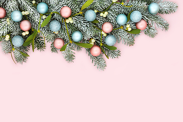 Image showing Festive Christmas Pink Background with Snow Fir and Tree Baubles