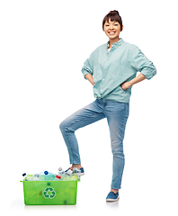 Image showing smiling young asian woman sorting plastic waste