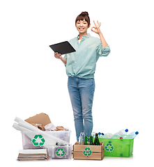 Image showing smiling asian woman with tablet pc sorting waste