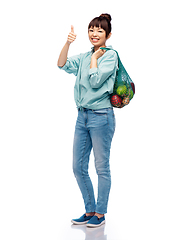 Image showing woman with food in string bag showing thumbs up